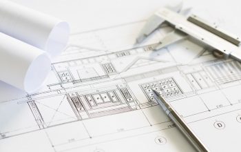 Construction plans and drawing tools on blueprints